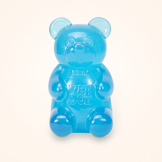 Blue NeeDoh Gummy Bear squishy on a cream background