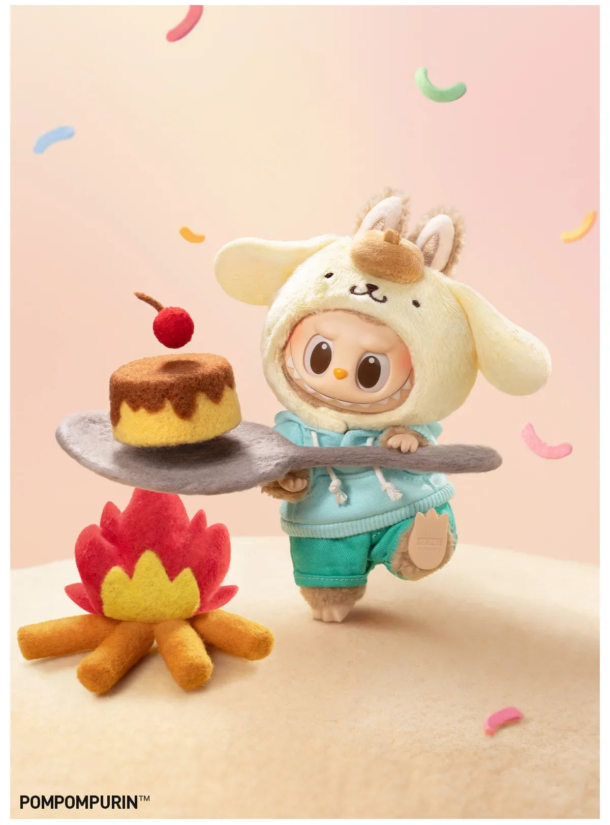 Pompompurin design from Labubu x Hello Kitty and Friends, in a teal hoodie, carrying a pudding on a spoon