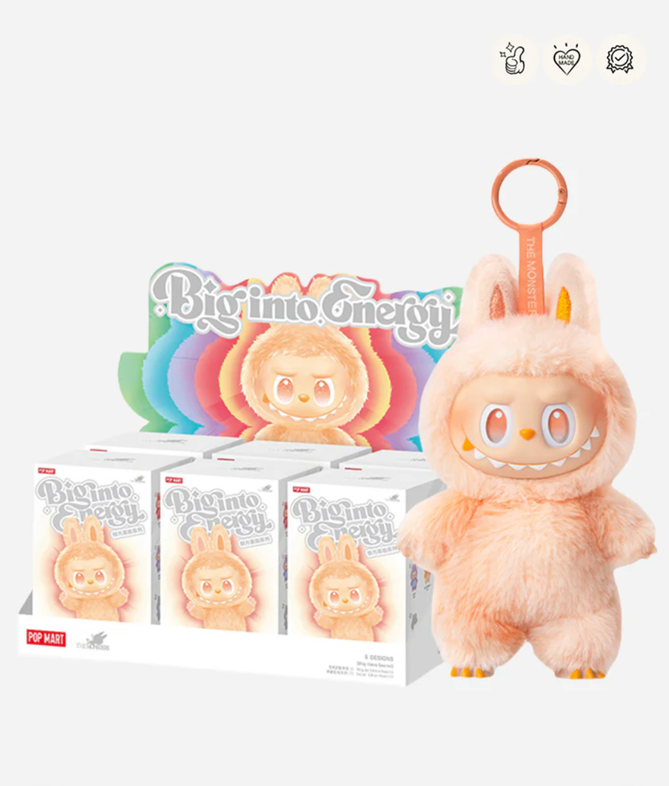 Labubu Big into Energy display case of sealed boxes next to the peach Happiness pendant; badge icons top right