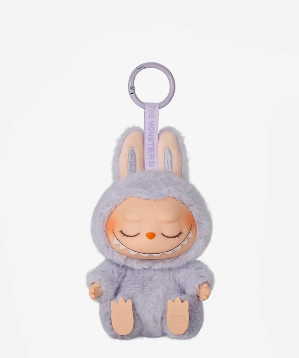 Zizi, the lavender Labubu Have a Seat figure with closed eyes, on a lilac keyring
