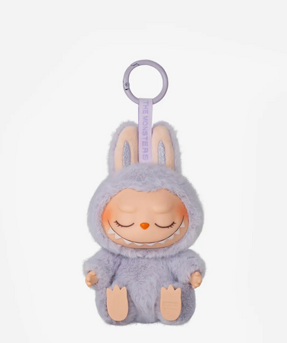 Zizi, the lavender Labubu Have a Seat figure with closed eyes, on a lilac keyring