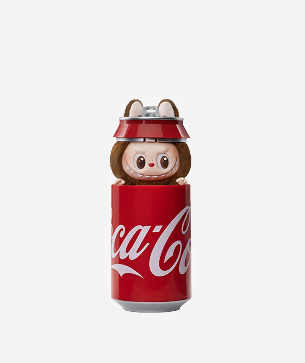 Brown Labubu Coca-Cola figure peeking out of a red Coca-Cola can, with the can lid on its head