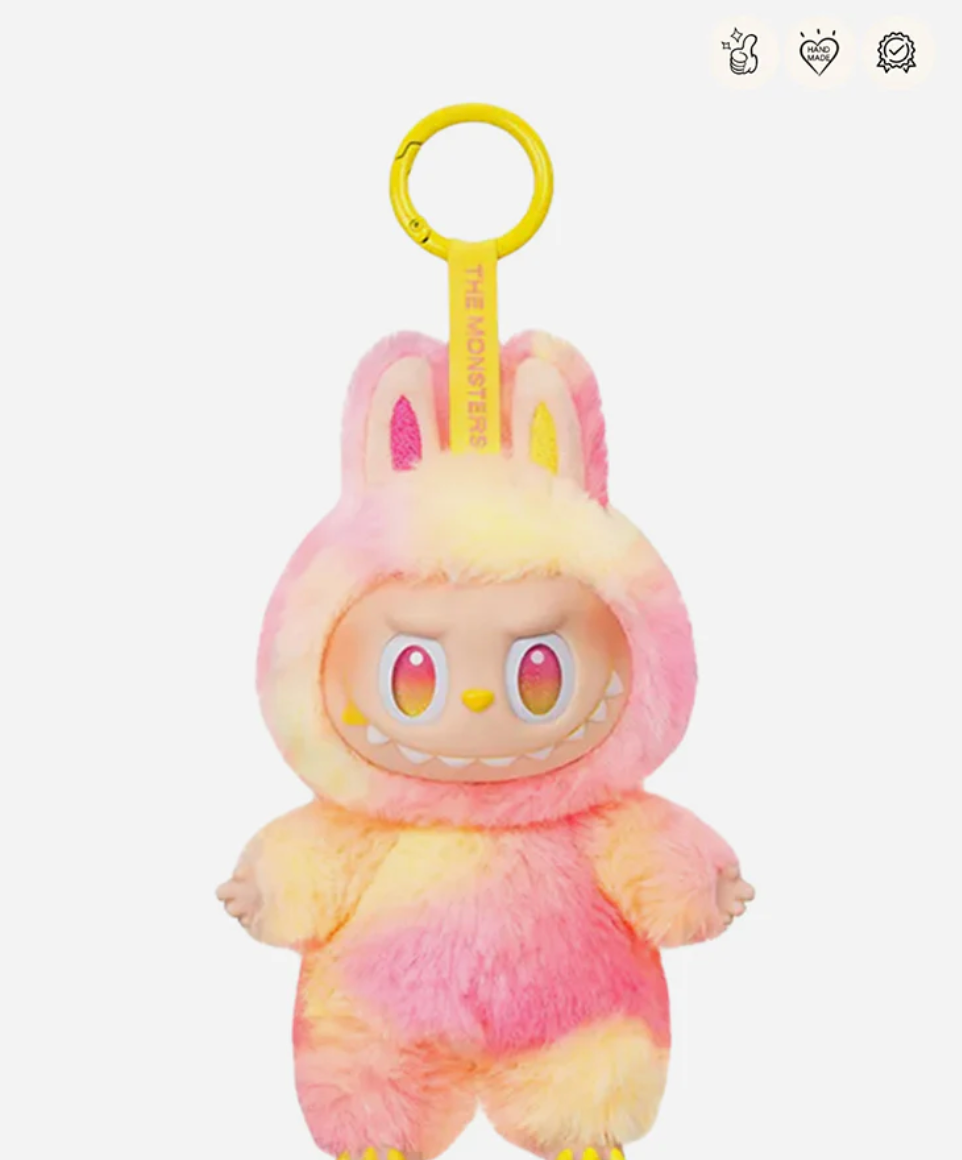 Loyalty, the pink and yellow Labubu Big into Energy pendant with a yellow keyring; small badge icons top right