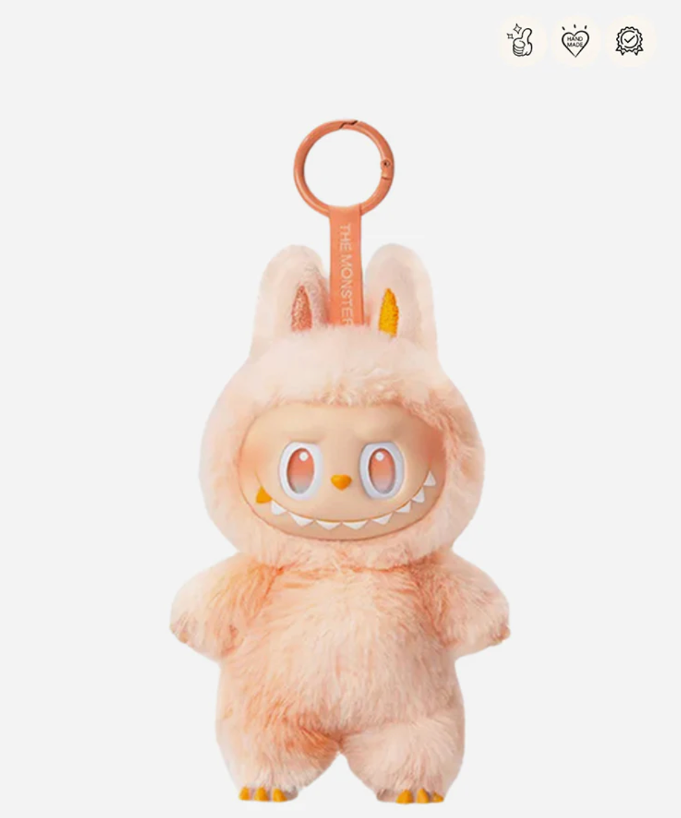 Happiness, the peach Labubu Big into Energy pendant with an orange keyring; small badge icons top right