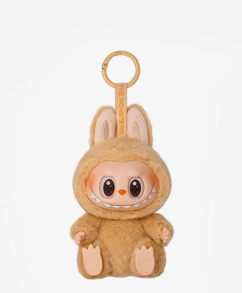 Baba, the caramel brown Labubu Have a Seat figure, on a gold keyring