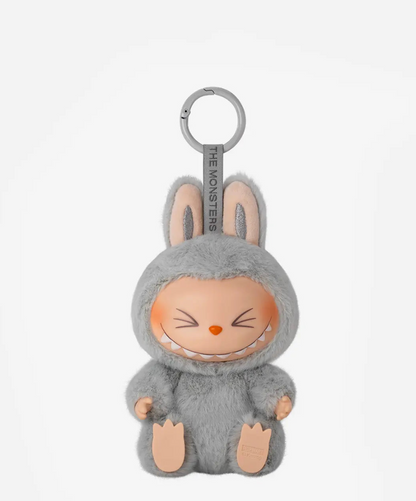 Hehe, the grey Labubu Have a Seat figure with squinting eyes, on a grey keyring