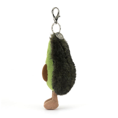 Jellycat Amuseables Avocado plush bag charm from the side, showing the dark green skin and the clasp