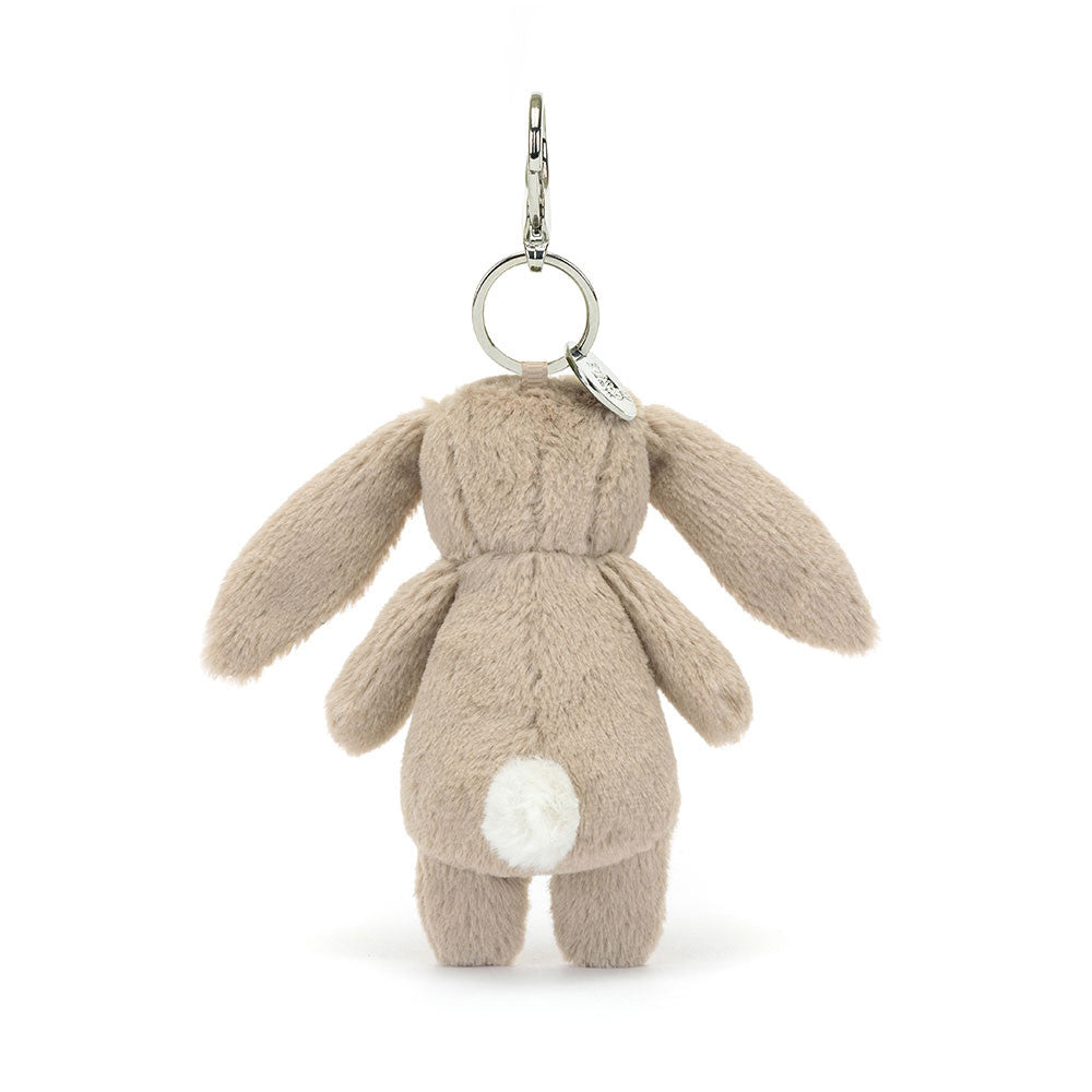 Back of the Jellycat Blossom Beige Bunny plush bag charm, with a white fluffy tail and long ears