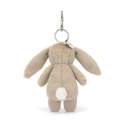 Back of the Jellycat Blossom Beige Bunny plush bag charm, with a white fluffy tail and long ears