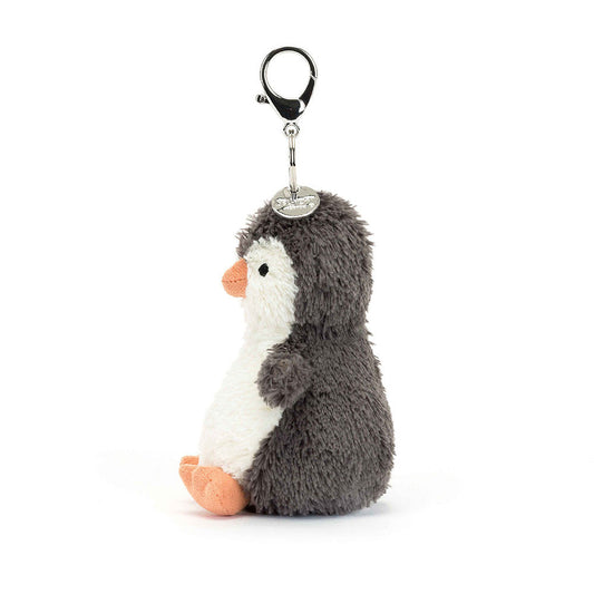 Jellycat Peanut Penguin plush bag charm from the side, showing its orange beak and the clasp with a round metal tag