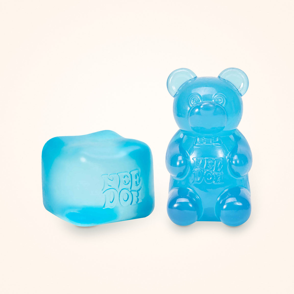 Squishy Gift Box Duo: a blue NeeDoh Nice Cube next to a blue NeeDoh Gummy Bear, shown to scale on a cream background