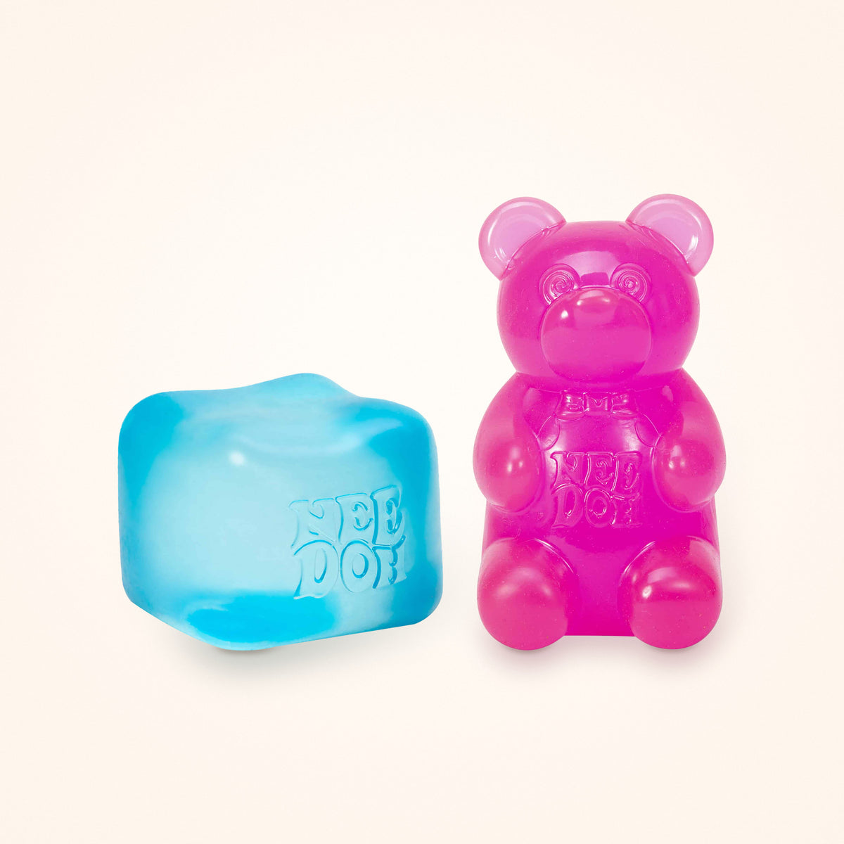 Squishy Gift Box Duo: a blue NeeDoh Nice Cube next to a pink NeeDoh Gummy Bear, shown to scale on a cream background
