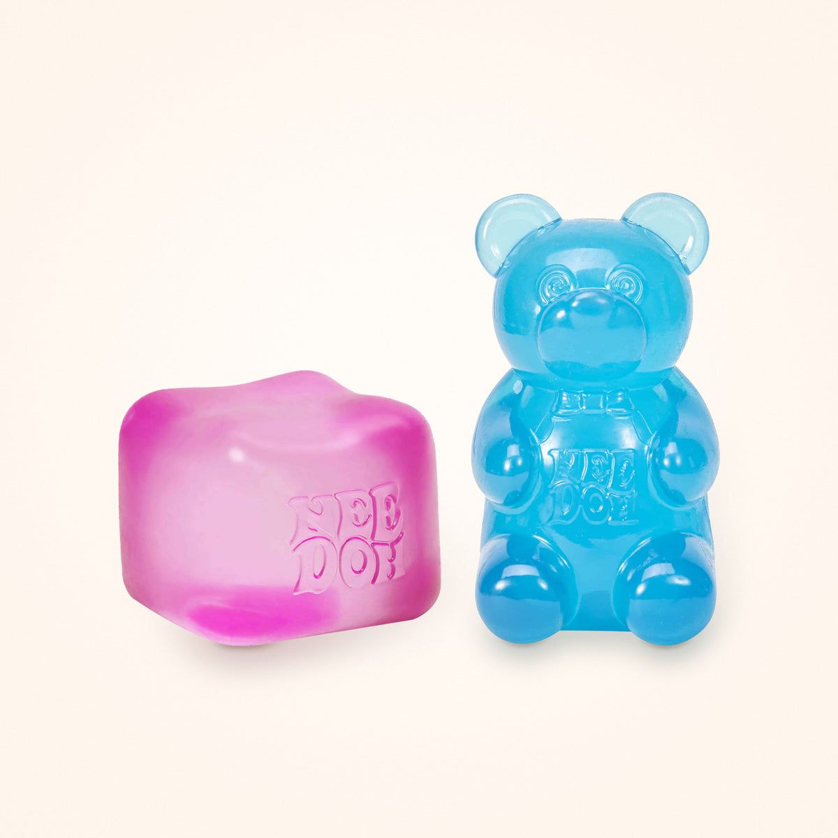 Squishy Gift Box Duo: a pink NeeDoh Nice Cube next to a blue NeeDoh Gummy Bear, shown to scale on a cream background
