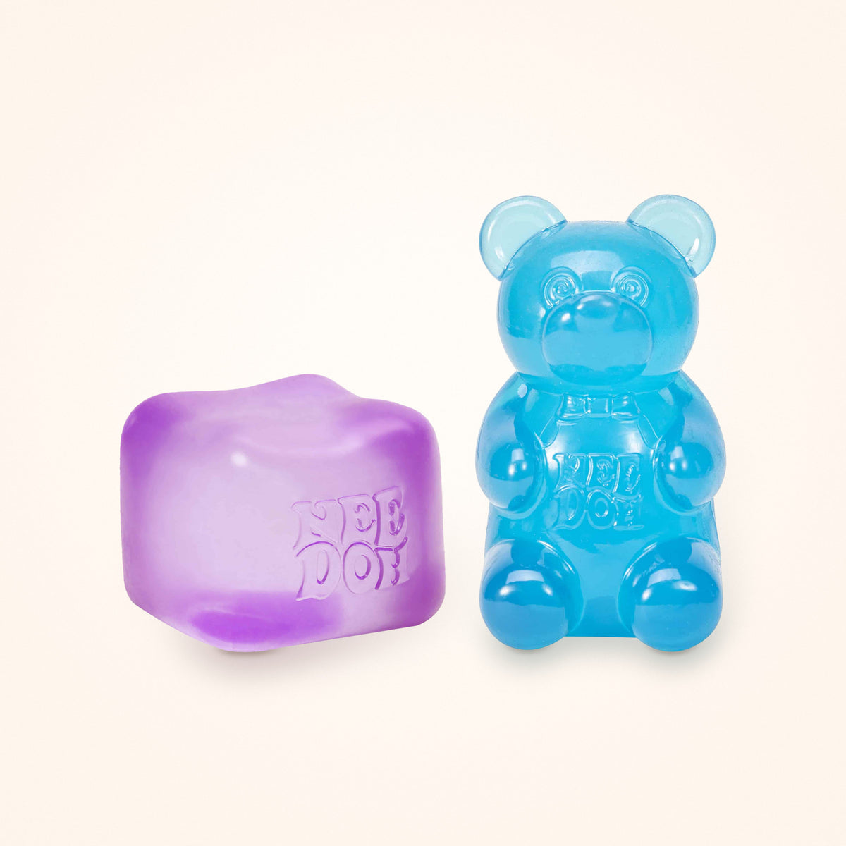 Squishy Gift Box Duo: a purple NeeDoh Nice Cube next to a blue NeeDoh Gummy Bear, shown to scale on a cream background