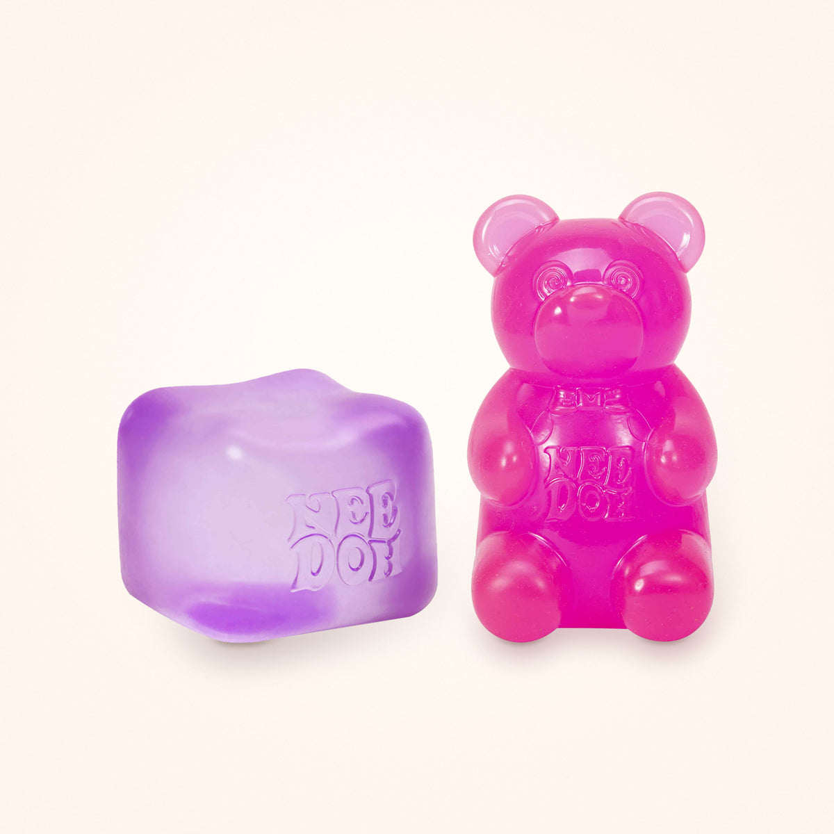 Squishy Gift Box Duo: a purple NeeDoh Nice Cube next to a pink NeeDoh Gummy Bear, shown to scale on a cream background