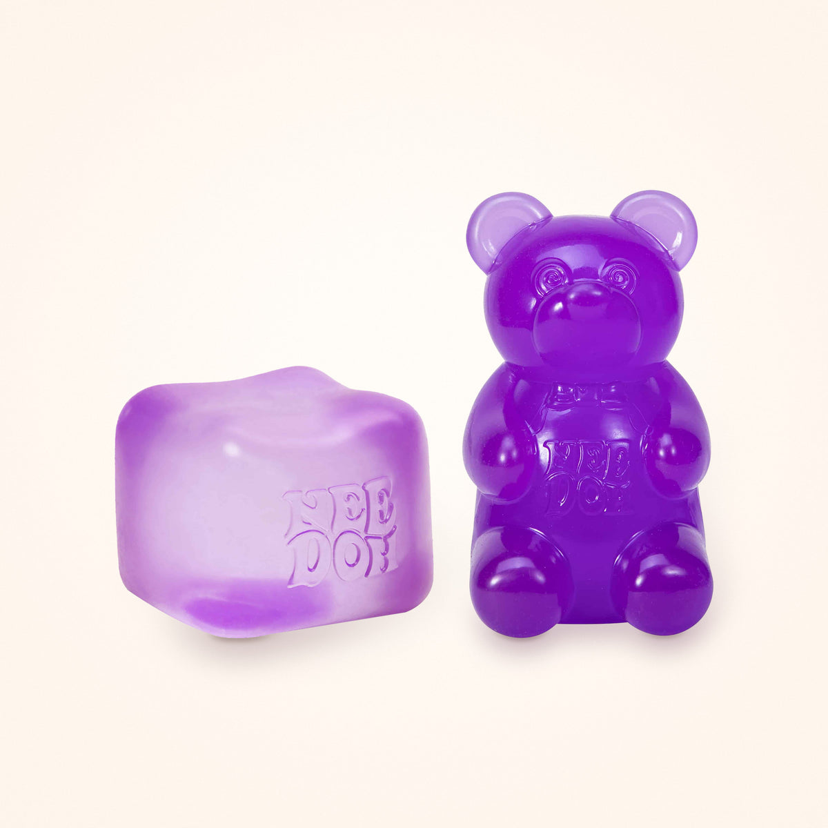 Squishy Gift Box Duo: a purple NeeDoh Nice Cube next to a purple NeeDoh Gummy Bear, shown to scale on a cream background