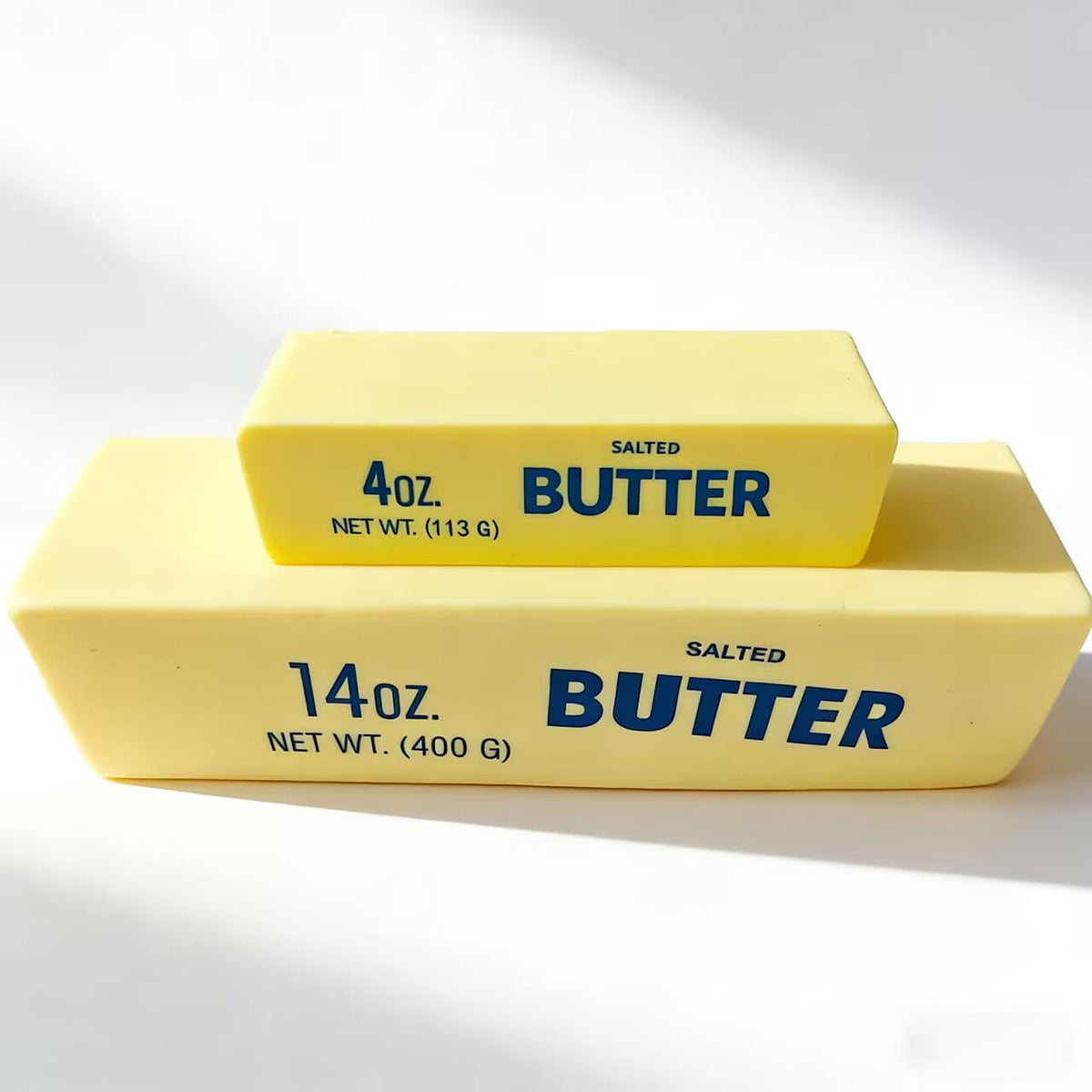 Butter Squishy in both sizes: the Mini stacked on top of the Giant on a white table
