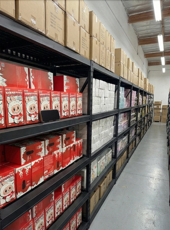 Red Labubu blind boxes and stacked cartons on black shelving along an aisle in our partner warehouse in Irvine, CA
