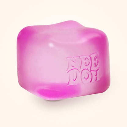 Pink NeeDoh Nice Cube squishy on a cream background