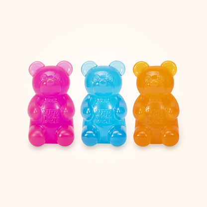 Squishy Stocking Stuffer: three NeeDoh Gummy Bears in pink, blue and orange, shown to scale on a cream background